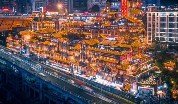 Hongyadong lit up at night beside the Qiansimen bridge
